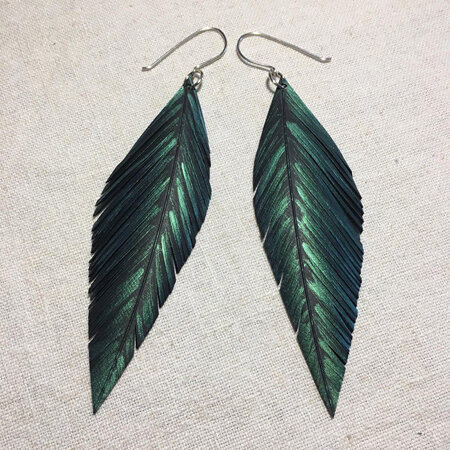 Pinned earrings with emerald