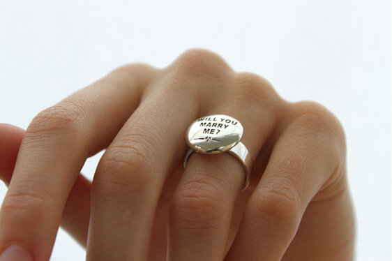 Wilshi button proposal ring on the hand
