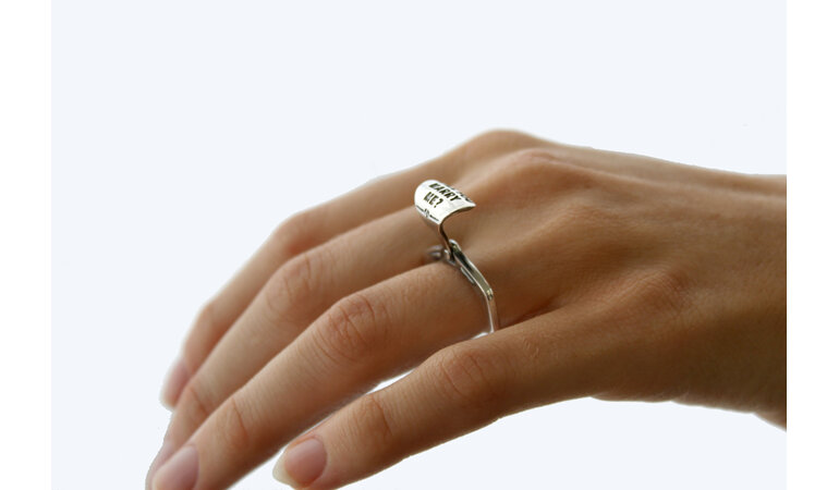 Wilshi tear tab proposal ring on the hand